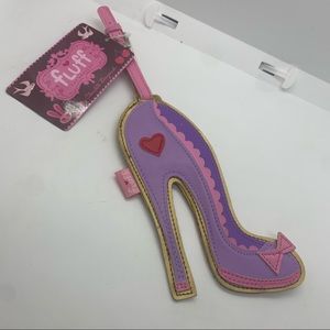 - “FLUFF” luggage tag